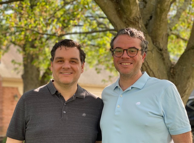 A couple of people posing for the camera
Description automatically generated